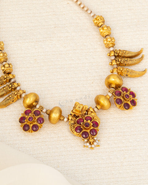 Antique Gold Polish Threaded Necklace With Mango Leaf Motifs And Multiple Kemp Ruby Flower Pendants